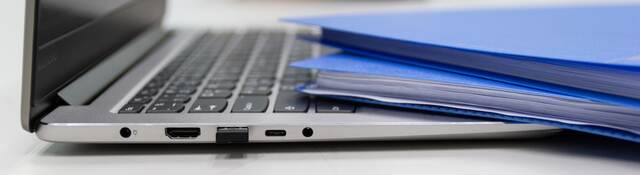 Folders and laptop on a desk.